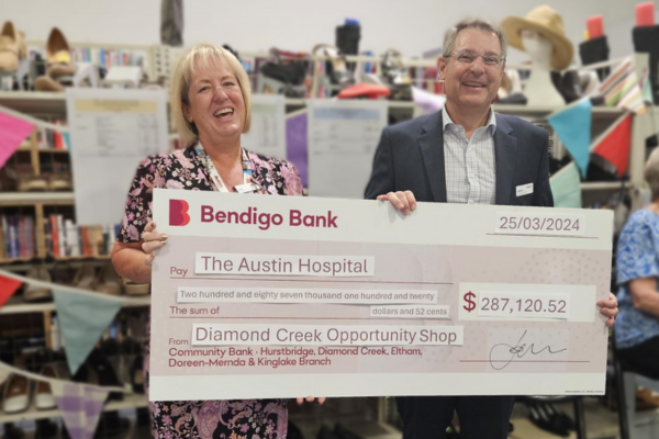Kemsley receiving the check at the Diamond Creek op shop